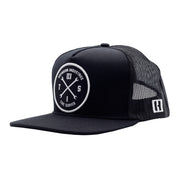 Black trucker hat with a circular embroidered patch featuring crossed wrenches, "Hoonigan Industries," and "Tire Slayer" text.