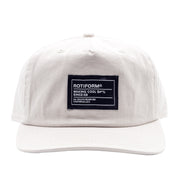 Unstructured white strapback hat featuring a black patch with "Making Cool S#*% Since 09" text and branding details.