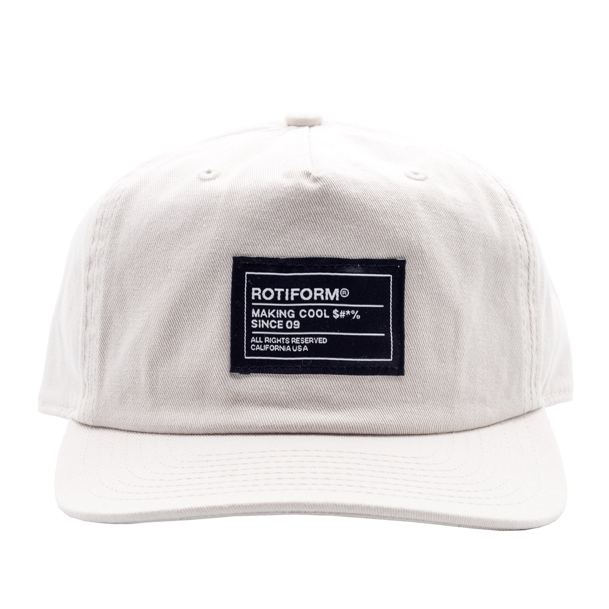 Unstructured white strapback hat featuring a black patch with "Making Cool S#*% Since 09" text and branding details.