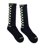 Hoonigan glow-in-the-dark socks featuring a checkerboard pattern and bold branding for motorsport enthusiasts.
