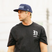 Hoonigan CHAPTERS Short Sleeve Tee featuring a bold graphic design on a black fabric, ideal for motorsport enthusiasts.