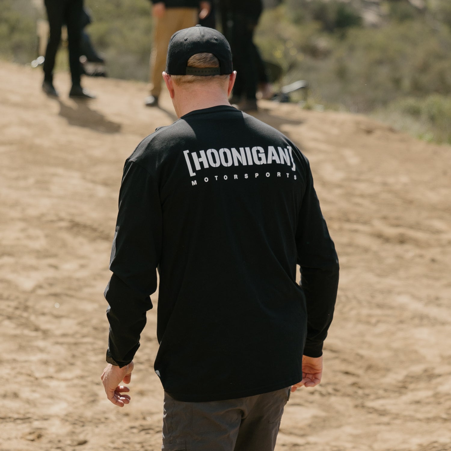 Hoonigan Motorsports long sleeve tee featuring bold graphic logo on front, black fabric, and comfortable fit.