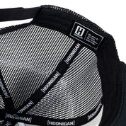 US Mags logo trucker hat with a black front panel and mesh back, featuring a bold embroidered logo in white.