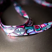 Colorful Hoonigan x Shreddy lanyard featuring logos and graphics, perfect for motorsport enthusiasts and daily use.