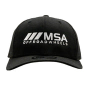 Black trucker hat featuring the MSA Wheels logo in white embroidery, perfect for off-road enthusiasts and motorsport fans.