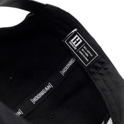 Inside view of Hoonigan CHAMPAGNE Snapback Hat showcasing brand label and adjustable strap for a perfect fit.