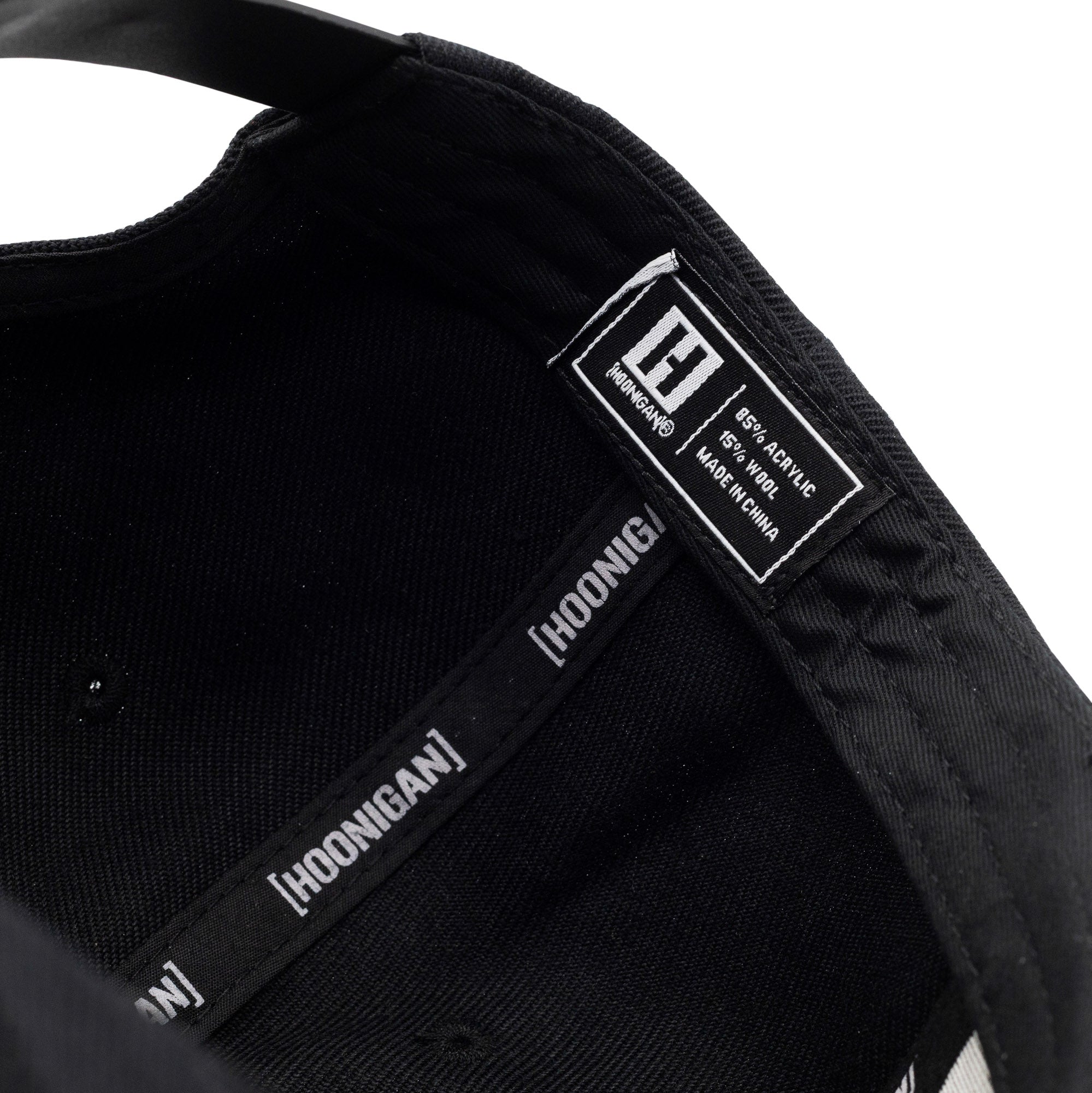 Interior view of Hoonigan VICTORY LAP Snapback Hat showcasing brand label and adjustable strap for a comfortable fit.