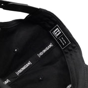 Inside view of Hoonigan RACEDAY unstructured strapback hat showcasing brand labels and black fabric lining.