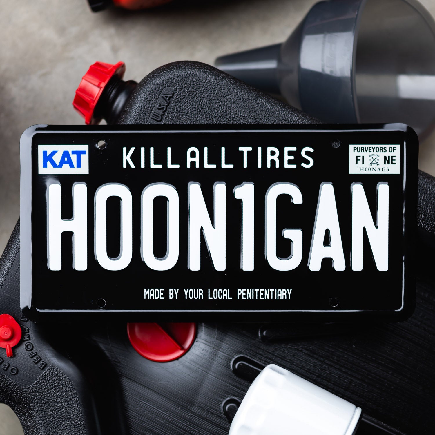 Hoonigan H00N1GAN license plate featuring bold white lettering on a black background, designed for automotive enthusiasts.