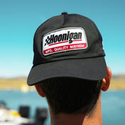 Black unstructured strapback hat featuring Hoonigan logo and "MFG. QUALITY MAYHEM" patch, perfect for motorsport enthusiasts.