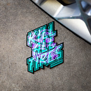 Hoonigan TREADWEAR KILL ALL TIRES sticker featuring bold, colorful text on a concrete surface near a wheel.