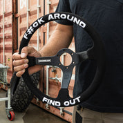 Limited edition Hoonigan steering wheel with "F#CK AROUND" and "FIND OUT" text, designed for motorsport enthusiasts.