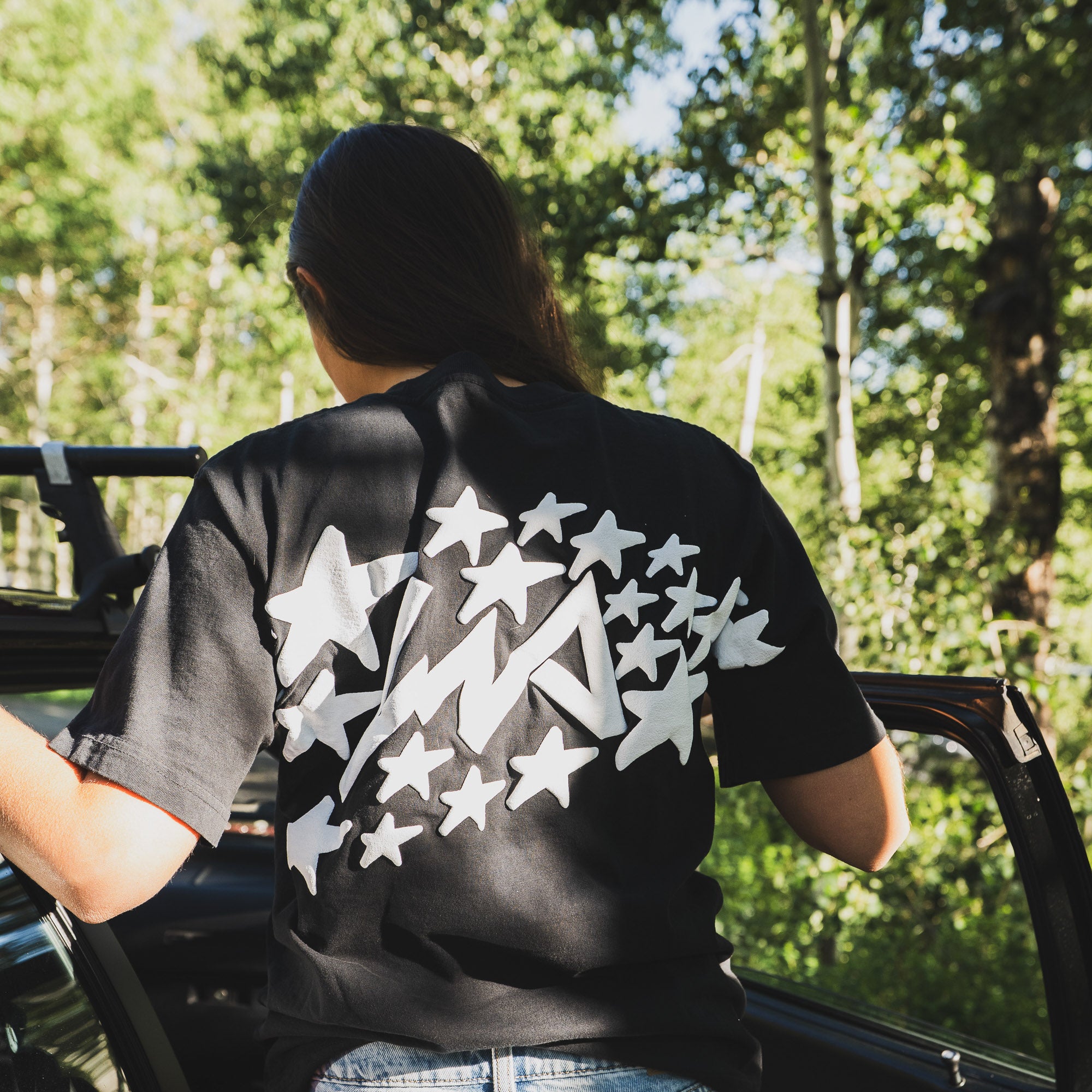 Black short sleeve t-shirt featuring a bold star graphic on the back, designed in collaboration with Lia Block.