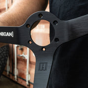 Close-up of the Hoonigan FIND OUT Limited Edition Steering Wheel showcasing its sleek design and logo details.