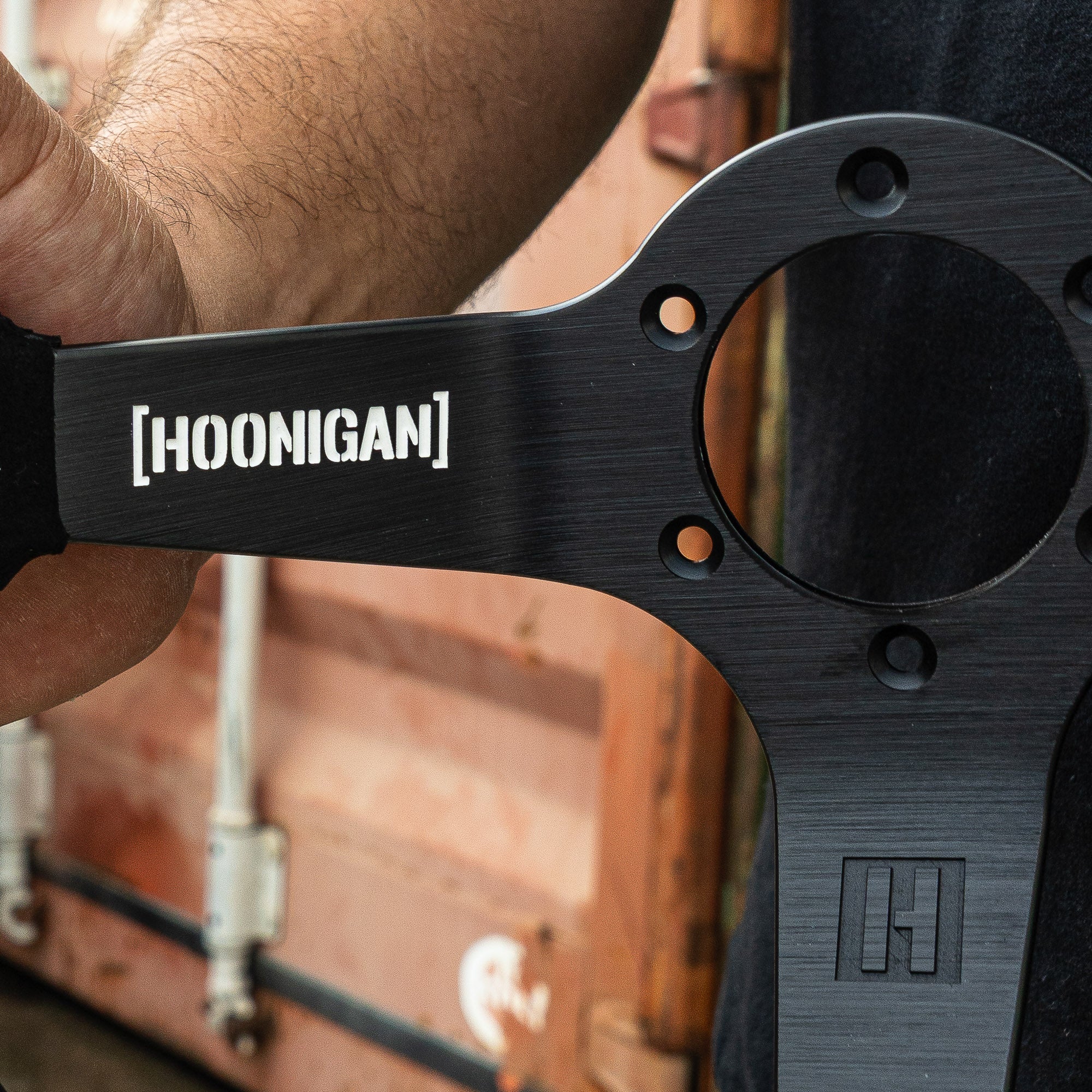 Limited edition Hoonigan steering wheel showcasing a sleek design and logo, perfect for motorsport enthusiasts.