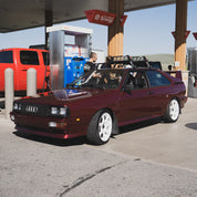 Hoonigan x Lia Block STAR CENSOR BAR Short Sleeve T-Shirt displayed with a classic Audi at a gas station, showcasing automotive culture.