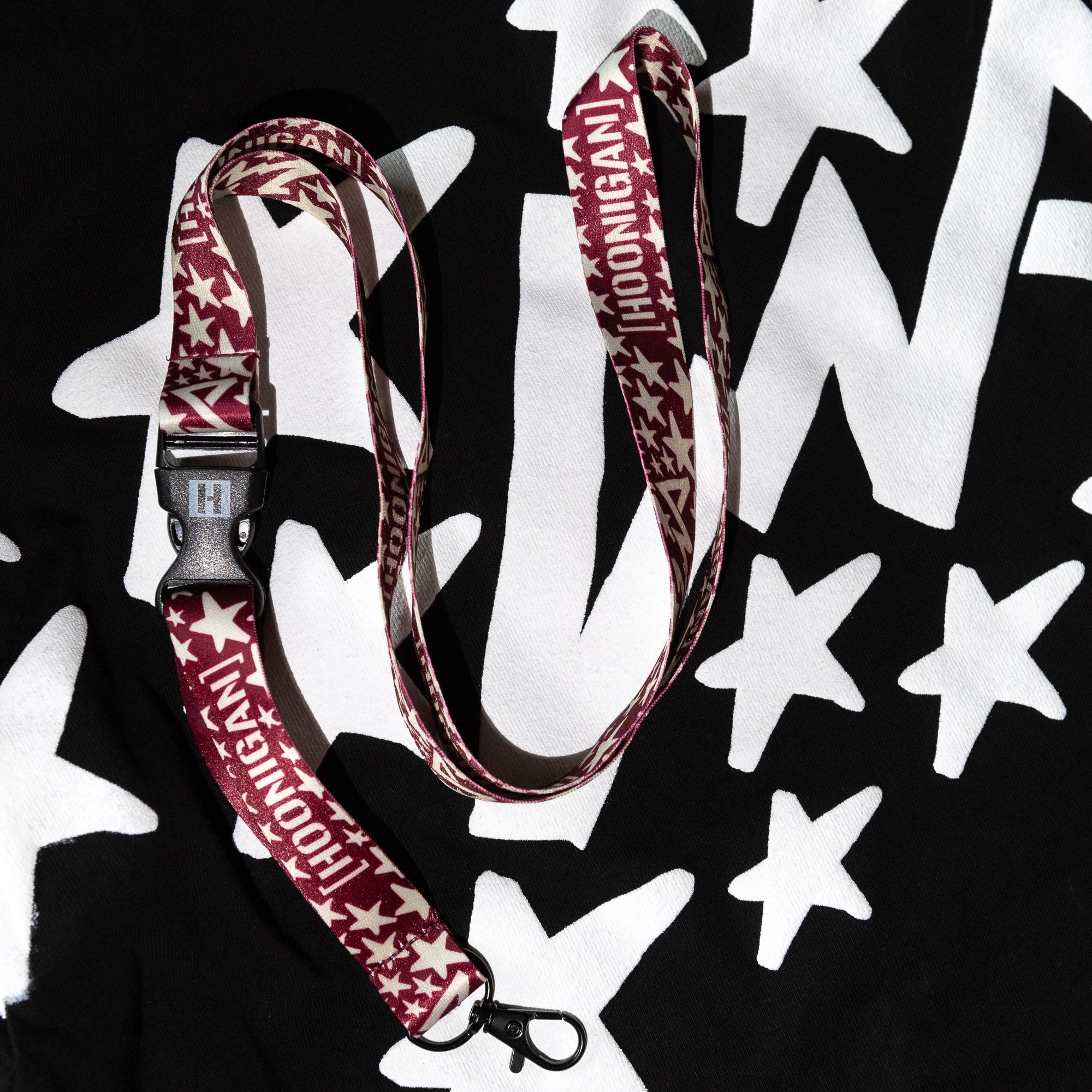 Hoonigan x Lia Block UR STAR lanyard featuring a bold star pattern and logo, perfect for motorsport enthusiasts.