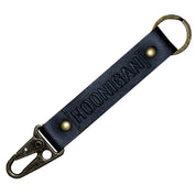 Hoonigan leather keychain featuring a sturdy clip and embossed logo, perfect for automotive enthusiasts.