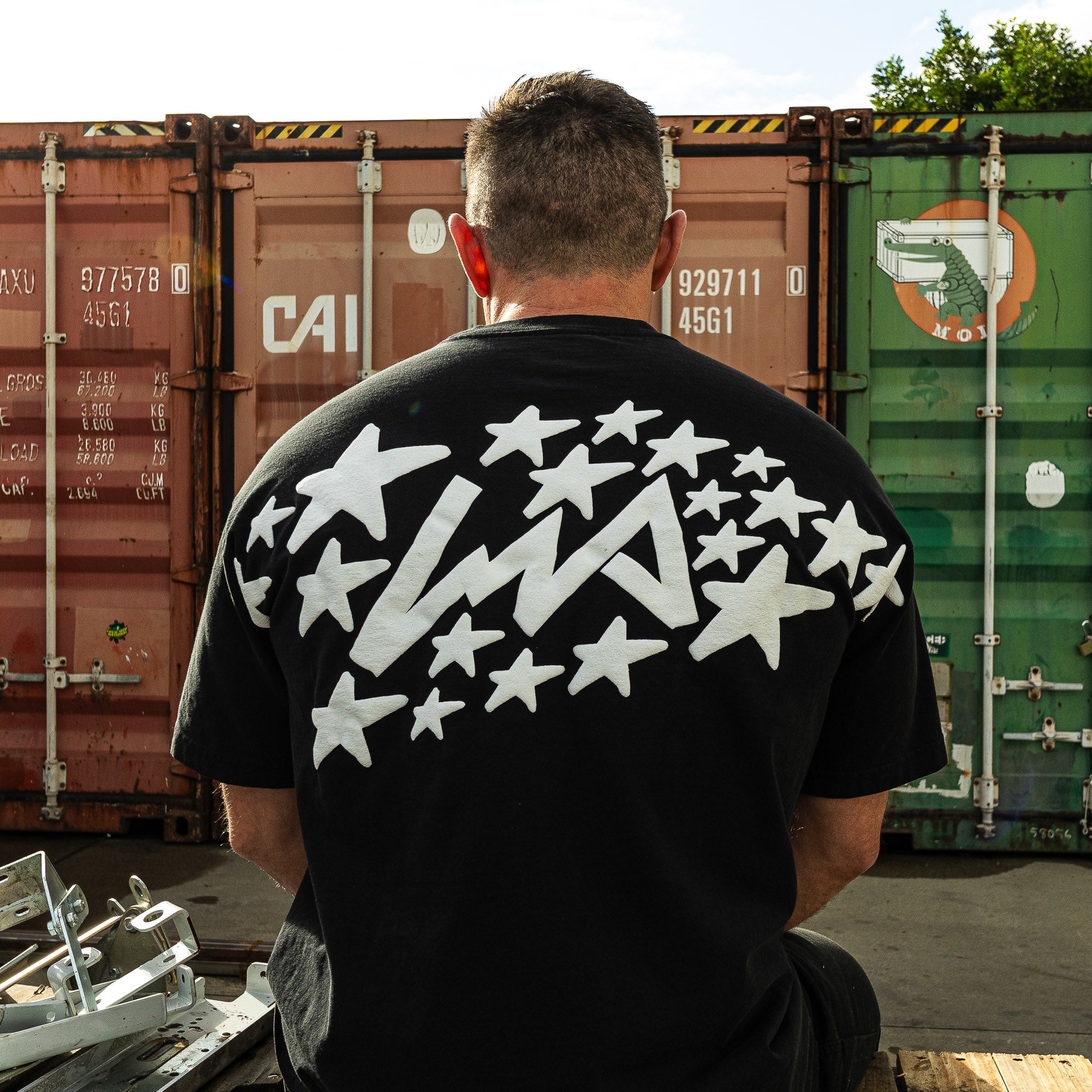 Black short sleeve t-shirt featuring a star graphic on the back, designed in collaboration with Lia Block for Hoonigan.