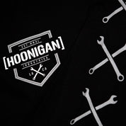 Black long sleeve t-shirt featuring Hoonigan logo and crossed wrench graphics, perfect for motorsport enthusiasts.