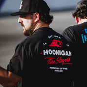 Black Hoonigan CHEATER SLICKS short sleeve t-shirt featuring bold graphics and a relaxed fit, perfect for motorsport fans.