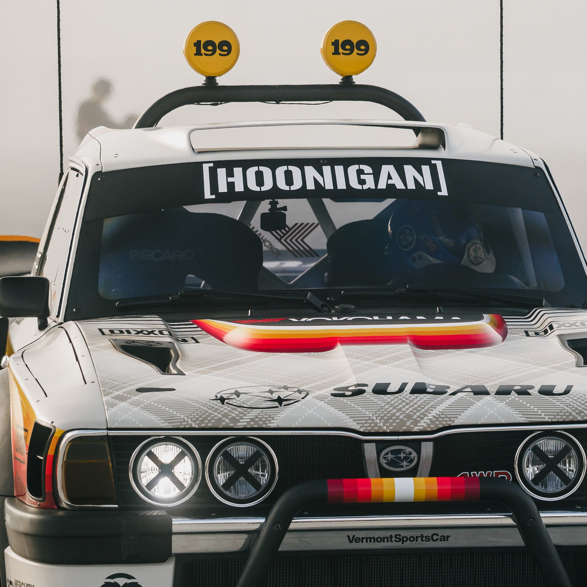 Large die cut Hoonigan censor bar bracket logo sticker displayed on a rally car, showcasing automotive culture and style.