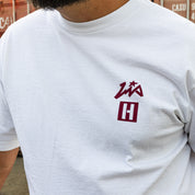 White short sleeve t-shirt featuring Hoonigan and Lia Block logos, perfect for motorsport enthusiasts and car culture fans.