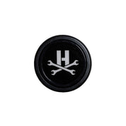 Limited edition Hoonigan steering wheel center featuring a bold logo with crossed wrenches on a black background.