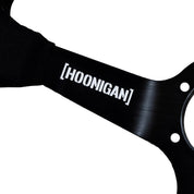 Limited edition Hoonigan steering wheel featuring a sleek design and bold branding for motorsport enthusiasts.