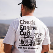 Hoonigan CHECK ENGINE CULT Short Sleeve Tee featuring a bold graphic design and vibrant colors on a black background.