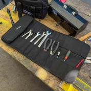 Hoonigan LIL TOOL ROLL displayed open with various tools neatly organized inside on a workbench.