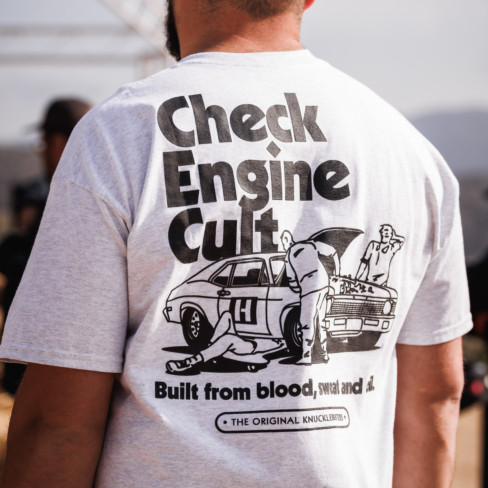 Hoonigan CHECK ENGINE CULT Short Sleeve Tee featuring a bold graphic design on a black cotton fabric.