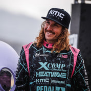 KMC LOGO snapback hat featuring a black design with a bold white logo embroidered on the front.