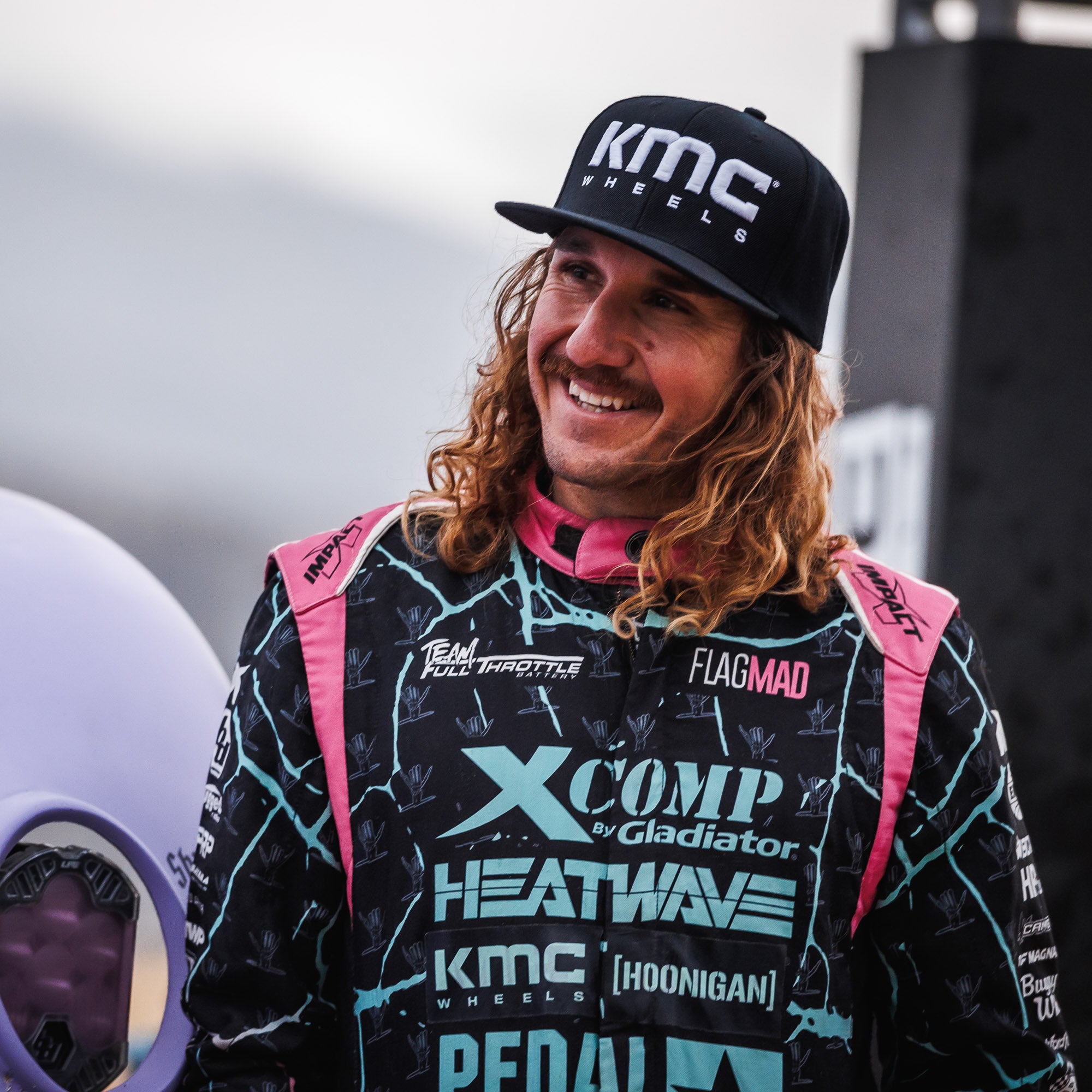 KMC LOGO snapback hat featuring a black design with a bold white logo embroidered on the front.