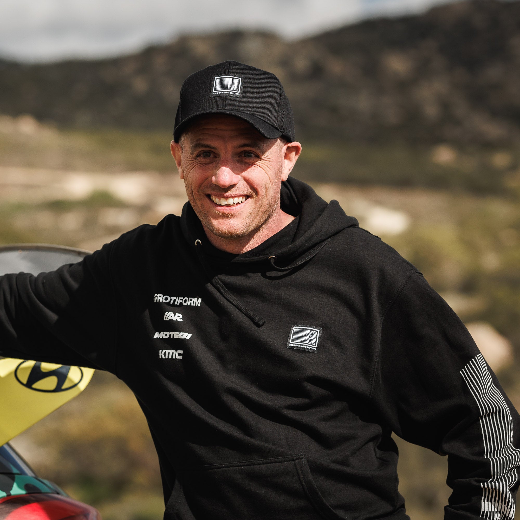 Hoonigan Motorsports pullover hoodie featuring a black design with bold white graphics on the front and a comfortable fit.