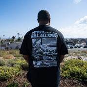 Man wearing Hoonigan WANGAN C1 Short Sleeve Tee, featuring a graphic design with a road scene and the text "KILL ALL TIRES.