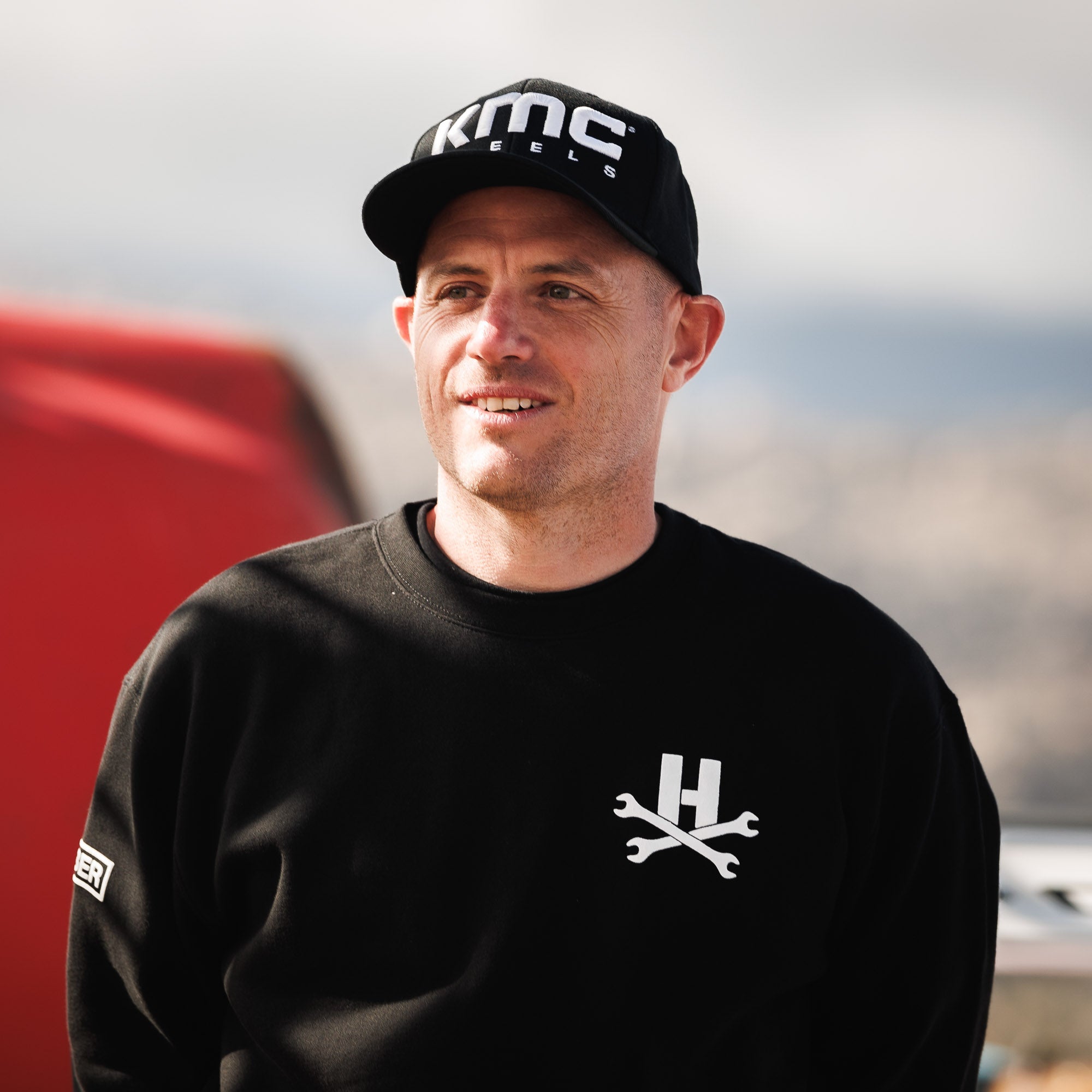 KMC LOGO Snapback Hat featuring a bold embroidered logo on a black cap with an adjustable snapback closure.