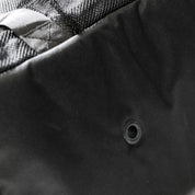 Close-up of the Hoonigan CENSOR BAR Spare Tire Tailgate Backpack showcasing durable fabric and reinforced grommet detail.