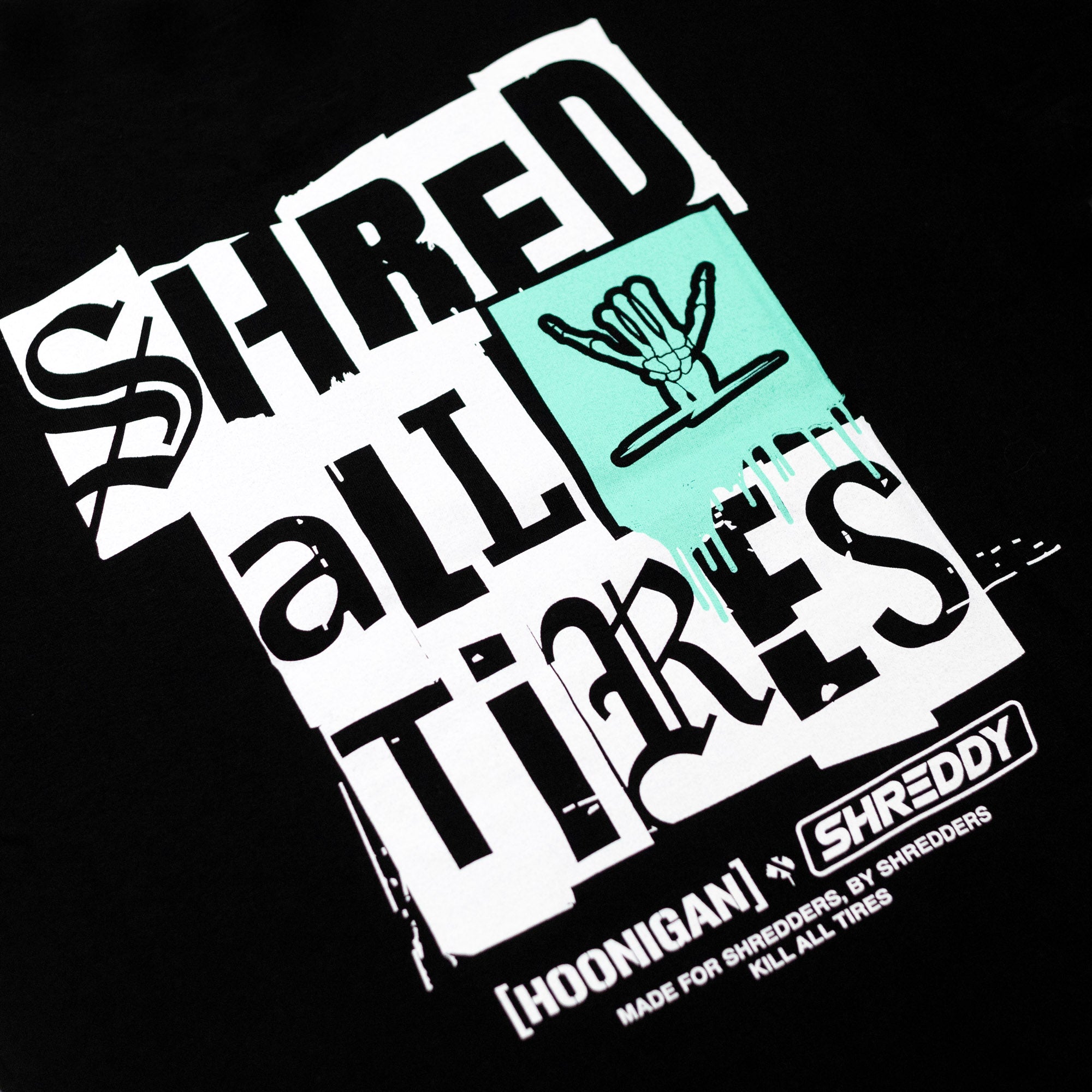 Black short sleeve t-shirt featuring bold "SHRED all TIRES" graphic with a hand sign, designed for motorsport enthusiasts.