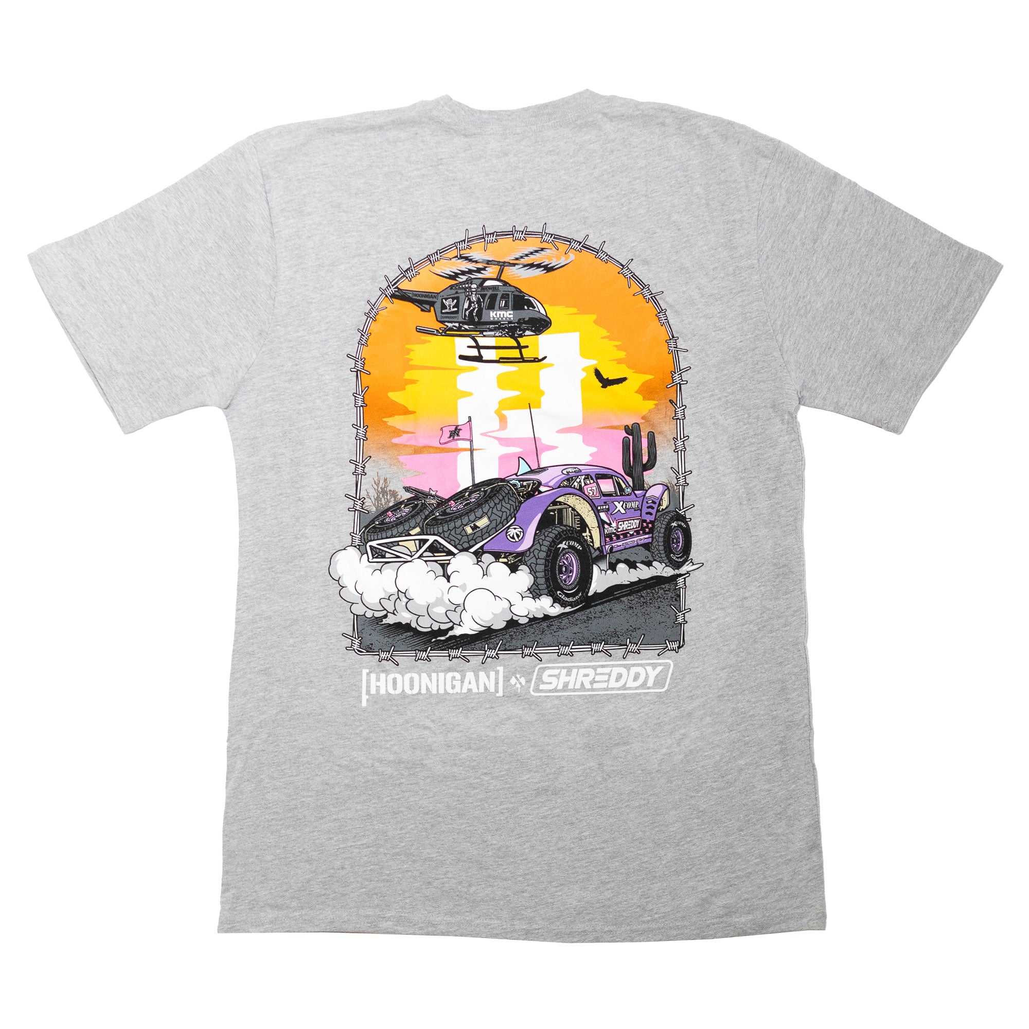 Gray short sleeve t-shirt featuring a vibrant graphic of a car kicking up dust under a helicopter, representing Hoonigan x Shreddy collaboration.