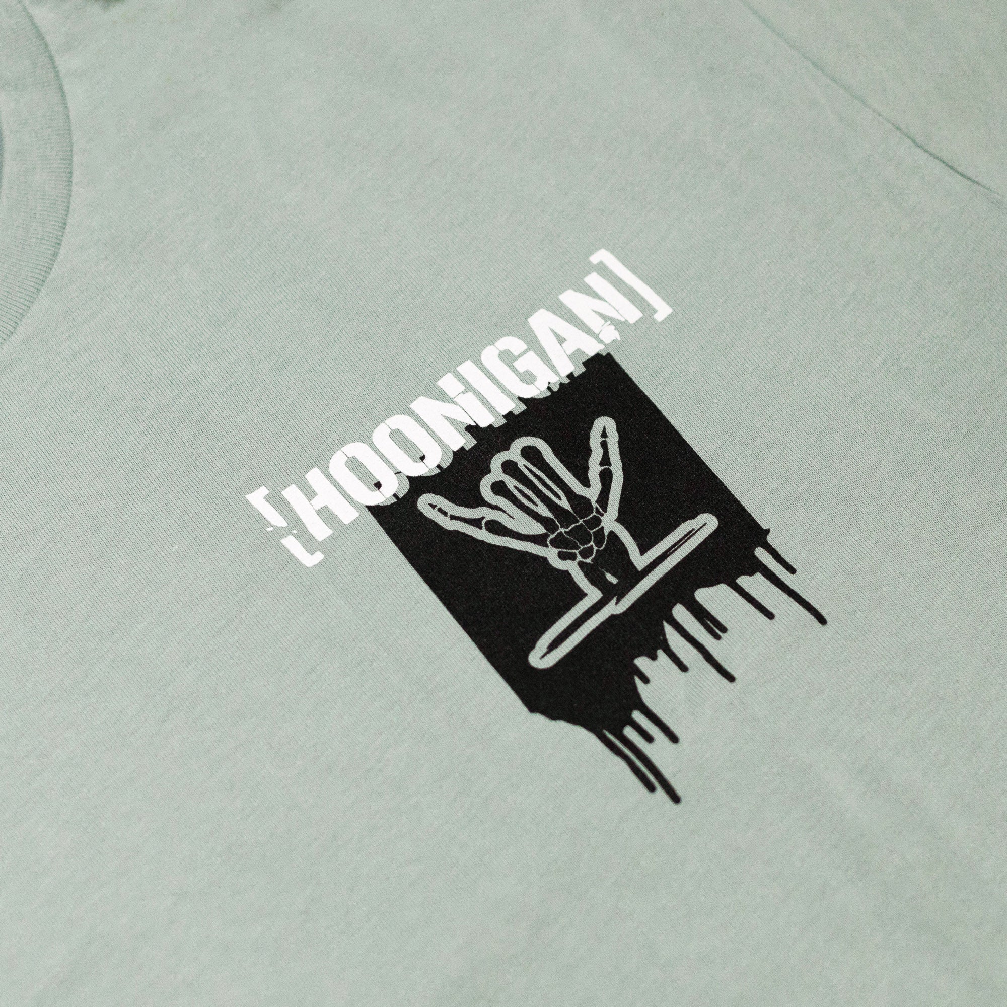 Light green short sleeve t-shirt featuring a bold Hoonigan logo with a dripping graphic design.