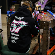 Hoonigan x Shreddy pullover hoodie featuring vibrant graphics, worn by a person welding in a workshop setting.