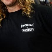 Black long sleeve t-shirt featuring Hoonigan and Shreddy logos, perfect for motorsport enthusiasts and car culture fans.