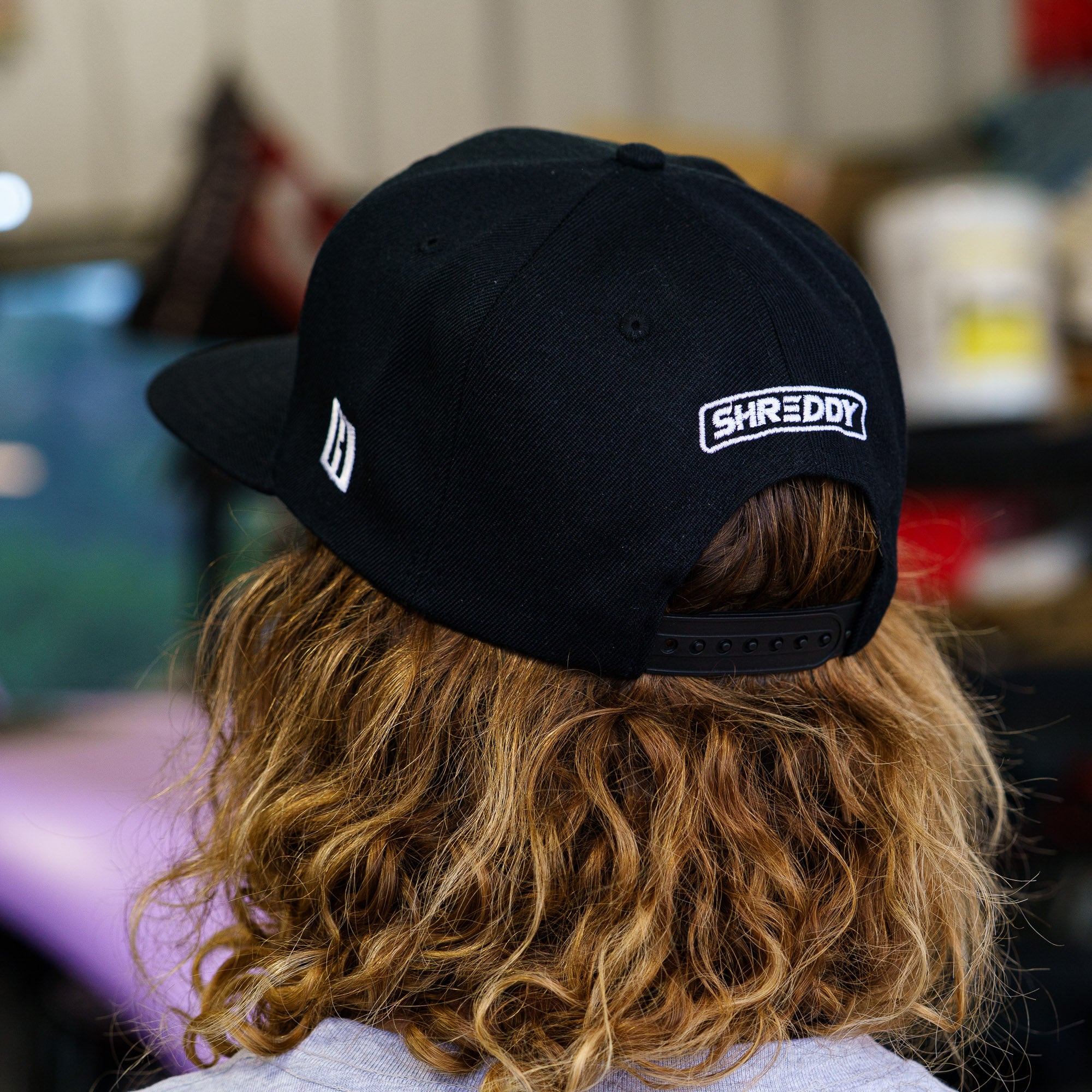 Black snapback hat featuring "SHREDDY" logo, designed for motorsport enthusiasts and aggressive driving fans.