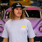 Hoonigan x Shreddy Desert Shred short sleeve t-shirt worn by a man in front of a modified off-road vehicle.
