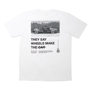 Short sleeve white t-shirt featuring a graphic of a car and the text "They Say Wheels Make The Car" on the back.