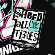 Hoonigan x Shreddy SHRED ALL TIRES sticker featuring bold text and a hand graphic, perfect for motorsport enthusiasts.
