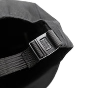 Close-up of the adjustable strap on a Hoonigan CENSOR BAR unstructured strapback hat, showcasing its durable buckle design.