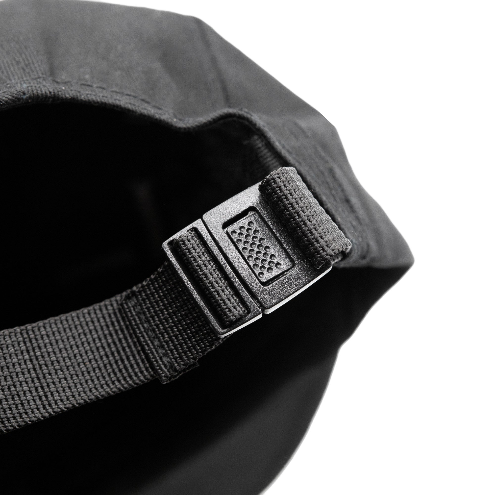Close-up of the adjustable strap on a Hoonigan CENSOR BAR unstructured strapback hat, showcasing its durable buckle design.