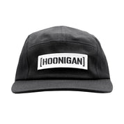 Black unstructured strapback hat featuring a prominent white embroidered Hoonigan logo on the front.